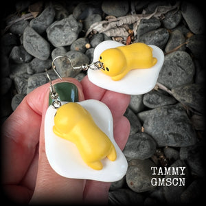 These earrings are TOO CUTE!!! Featuring the adorable Gudetama lazy egg man himself laying on a bed of egg whites, these earrings measure just on 6cms and weigh approx 8 grams.
This pair has been made on stainless steel french hooks, suitable for pierced ears.