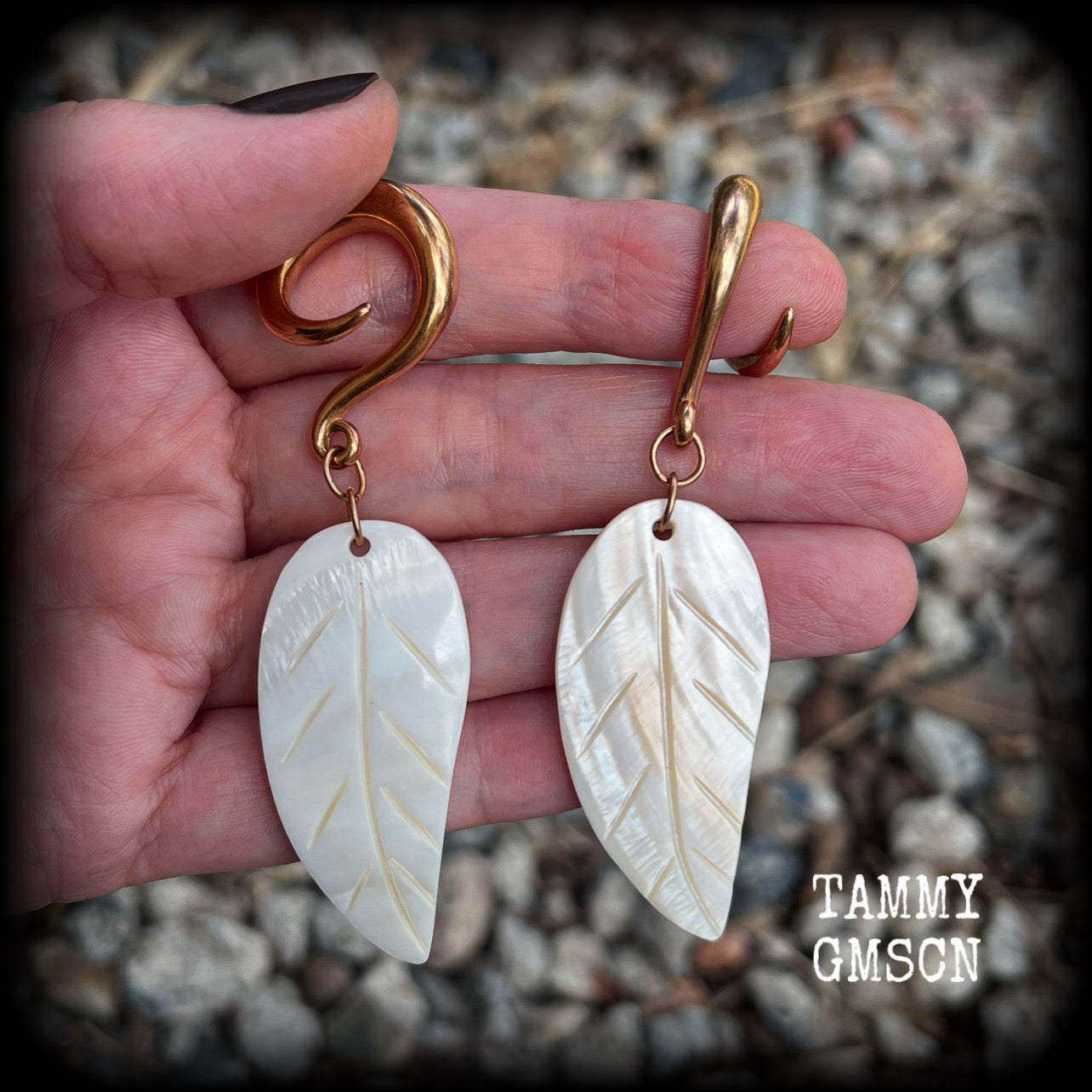 Featuring beautiful milky white carved shell leaves, these earrings are simply beautiful, measuring just over 8 cms from tip to tip, and are not too heavy at only 13 grams each.
This pair has been made on 2 gauge (6mm) surgical steel full curl hooks, suitable for stretched lobes.