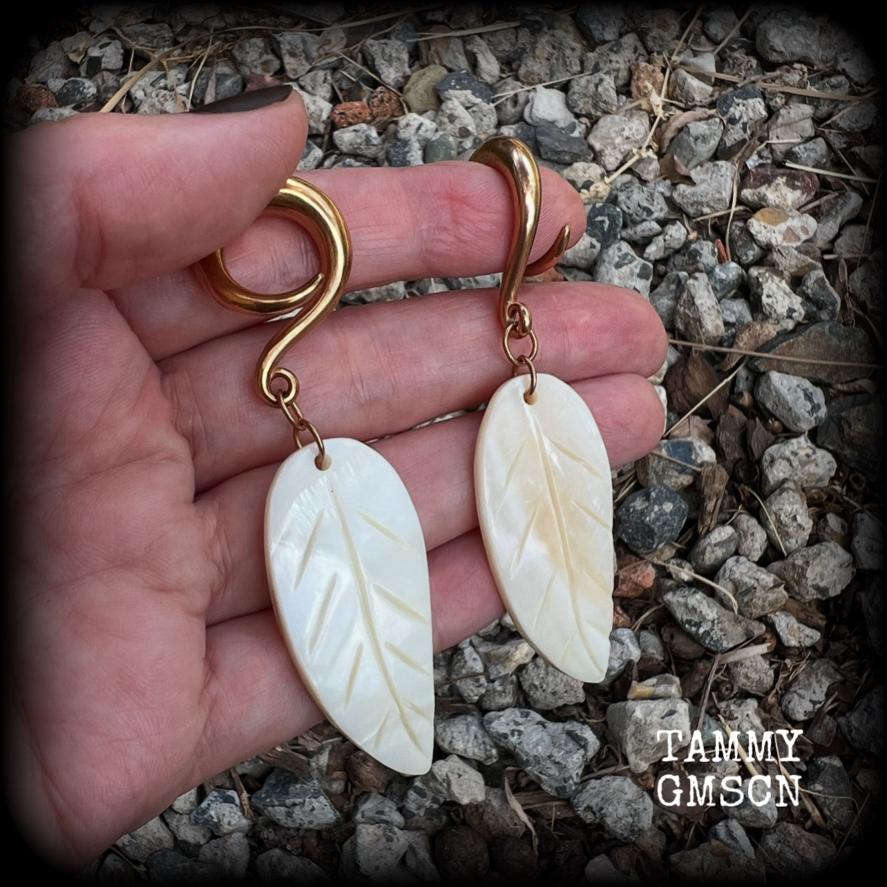 Featuring beautiful milky white carved shell leaves, these earrings are simply beautiful, measuring just over 8 cms from tip to tip, and are not too heavy at only 13 grams each.
This pair has been made on 2 gauge (6mm) surgical steel full curl hooks, suitable for stretched lobes.