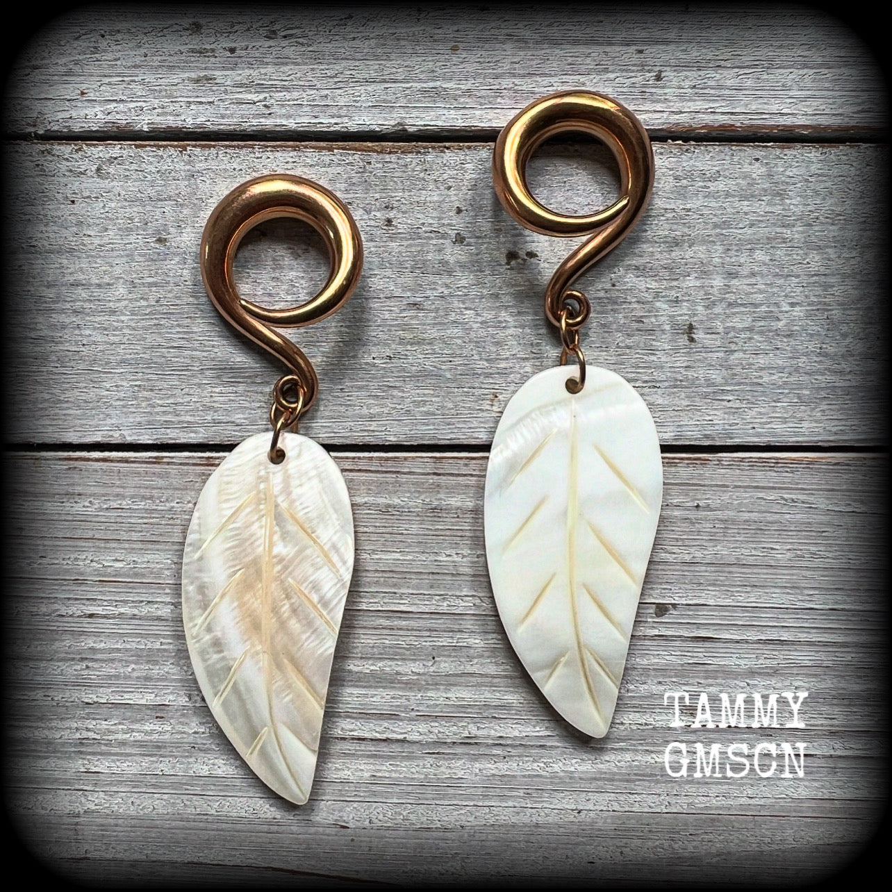 Featuring beautiful milky white carved shell leaves, these earrings are simply beautiful, measuring just over 8 cms from tip to tip, and are not too heavy at only 13 grams each.
This pair has been made on 2 gauge (6mm) surgical steel full curl hooks, suitable for stretched lobes.