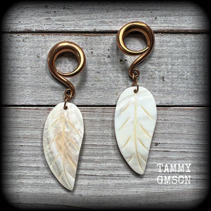 Featuring beautiful milky white carved shell leaves, these earrings are simply beautiful, measuring just over 8 cms from tip to tip, and are not too heavy at only 13 grams each.
This pair has been made on 2 gauge (6mm) surgical steel full curl hooks, suitable for stretched lobes.