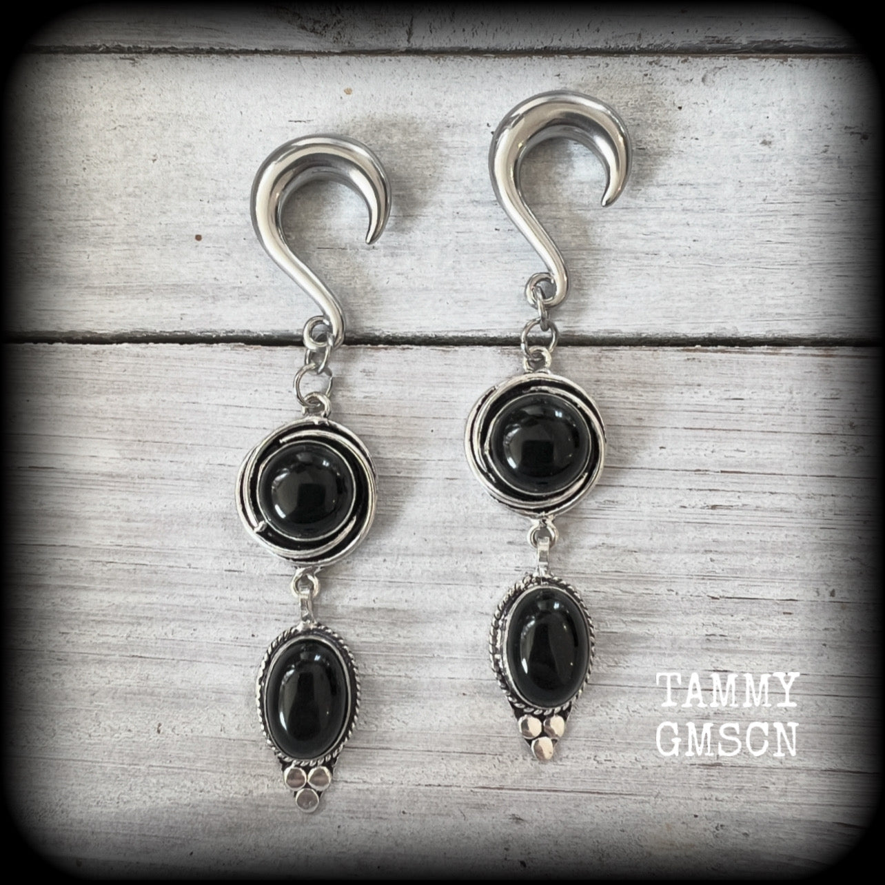 These gauged earrings have been made with gorgeous pitch black polished obsidian gemstones in a beautiful boho antique silver setting, measuring just under 9cms from tip to tip, and weighing approx 12 grams each, nice and lightweight.

These earrings have been made on 2 gauge (6mm) surgical steel half curl hooks, to be worn in stretched lobes.
