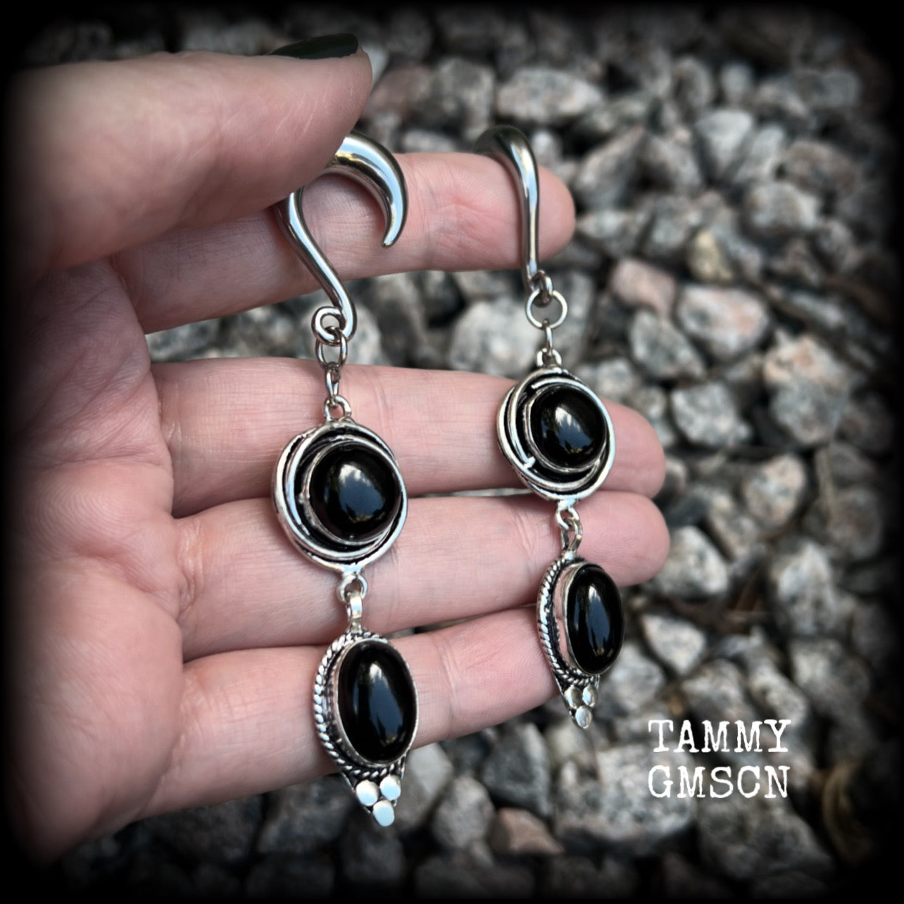 These gauged earrings have been made with gorgeous pitch black polished obsidian gemstones in a beautiful boho antique silver setting, measuring just under 9cms from tip to tip, and weighing approx 12 grams each, nice and lightweight.

These earrings have been made on 2 gauge (6mm) surgical steel half curl hooks, to be worn in stretched lobes.
