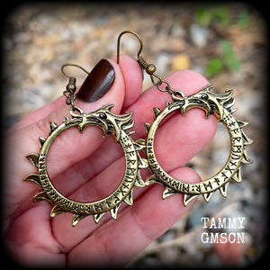 These gorgeous earrings feature a bright antique bronze Ouroborous snake inscribed with runes, measuring just on 6.5cms, nice and light weight at approx 6 grams each.

This pair has been made with antique bronze french hooks suitable for pierced ears.