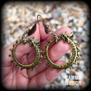 These gorgeous earrings feature a bright antique bronze Ouroborous snake inscribed with runes, measuring just on 6.5cms, nice and light weight at approx 6 grams each.

This pair has been made with antique bronze french hooks suitable for pierced ears.