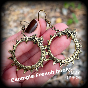 These gorgeous earrings feature a bright antique bronze Ouroborous snake inscribed with runes, measuring just on 6.5cms, nice and light weight at approx 6 grams each.

This pair has been made with antique bronze french hooks suitable for pierced ears.