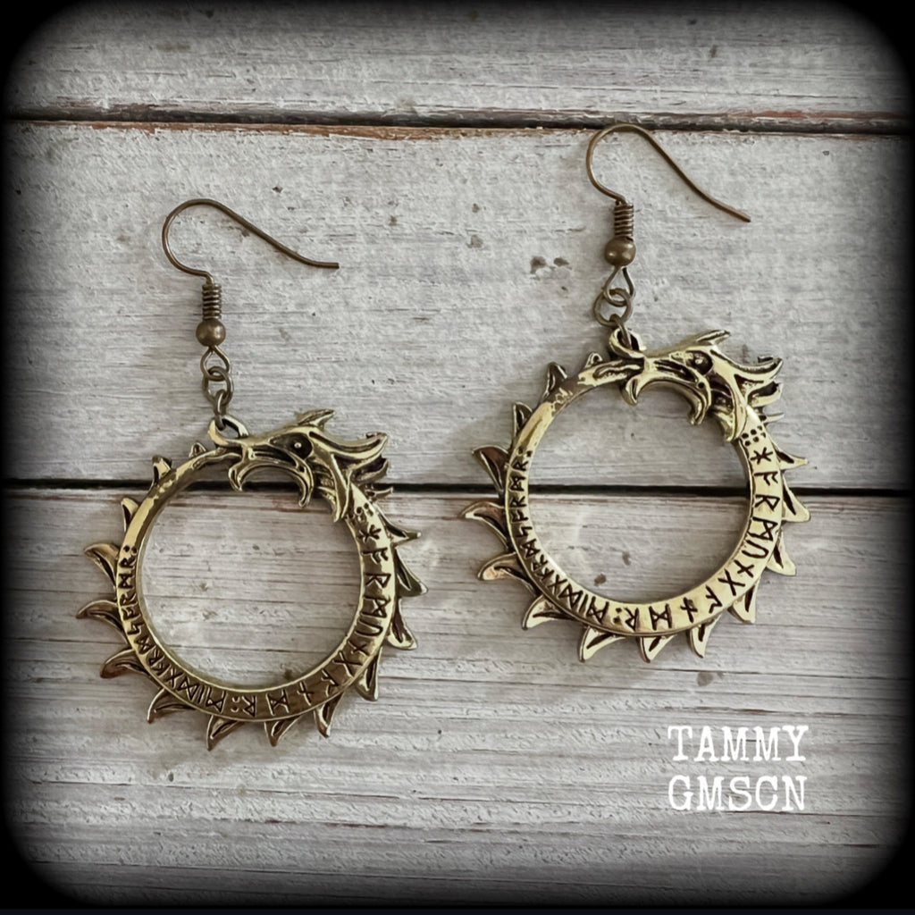 These gorgeous earrings feature a bright antique bronze Ouroborous snake inscribed with runes, measuring just on 6.5cms, nice and light weight at approx 6 grams each.

This pair has been made with antique bronze french hooks suitable for pierced ears.