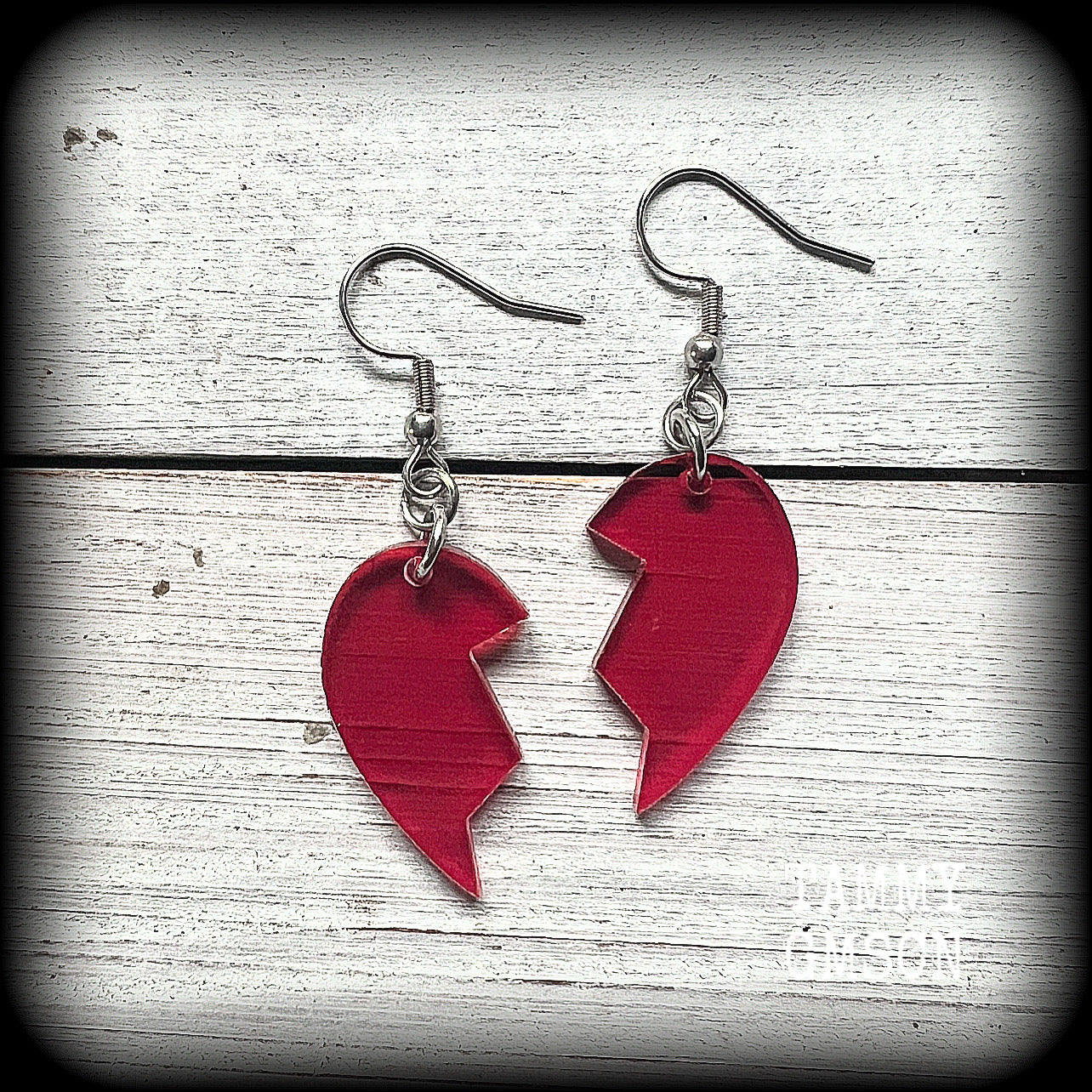 This pair of earrings feature a red acrylic heart broken in two, measuring just over 5cms from tip to tip, these earrings are lovely and lightweight, weighing only a few grams each.
This pair has been made on stainless steel french hooks, suitable for pierced ears.