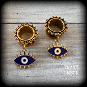 These stunning tunnel earrings feature gorgeous blue and white enamel and antique gold turkish evil eye charms, are nice and lightweight, weighing approx 10 grams each, measuring approx 5cms from tip to tip.

This pair has been made on 3/4” (19mm) gauge ornate surgical steel screw fit tunnels.