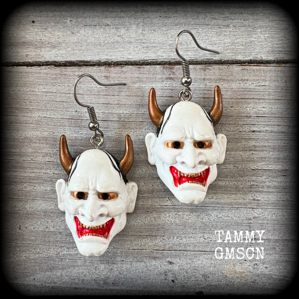 Featuring traditional red white and gold carved wood hannya mask charms, these unique earrings measure just on 6cms from tip to tip, and weigh only 5 grams each.

This pair have been made with stainless steel french hooks, for pierced ears.