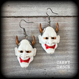 Featuring traditional red white and gold carved wood hannya mask charms, these unique earrings measure just on 6cms from tip to tip, and weigh only 5 grams each.

This pair have been made with stainless steel french hooks, for pierced ears.