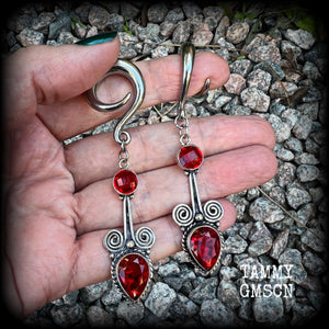 These stunning dangly gauged earrings feature gorgeous deep red faceted garnet gemstones in a beautiful boho antique silver setting, measuring just over 8cms from tip to tip, and weigh approx 12 grams each.  This pair have been made with 2 gauge (6mm) surgical steel full curl hooks, to be worn in stretched lobes.