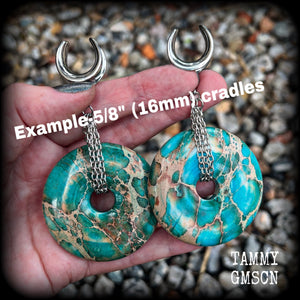 These ear weights have been made with gorgeous Turquoise ocean jasper donut gemstones and antique silver chain, measuring just over 9cms from tip to tip, and weighing approx 41grams each.
This pair have been made on 5/8" (16mm) surgical steel cradles hooks, to be worn in stretched lobes.