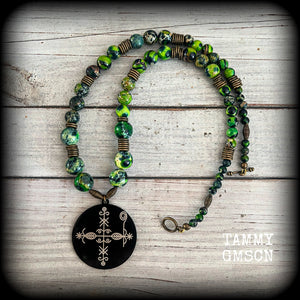 🔥 Papa Legba is the gatekeeper between the human and spirit worlds, and no human can reach the other spirits without Papa Legba’s permission. At the spiritual crossroads, Papa Legba decides whether a person is allowed to speak with other spirits 🔥

As with all the pieces in our Papa Legba range, this necklace is made with stone skulls in rich, beautiful, earthy organic colours, in honour of Papa Legba.

This necklace features gorgeous forest green kamababa jasper and antique bronze beads, with a black tit