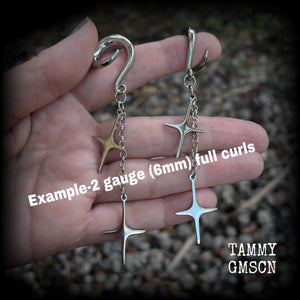 Measuring just over 10cms from tip to tip, these earrings feature fabulously kitschy retro stars dangling from stainless steel chains, weighing approx. 5 grams a piece. This pair has been made on 2 gauge (6mm) surgical steel full curl hooks