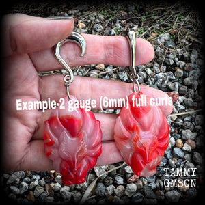 These gorgeous earrings feature carved Japanese jade kitsune, weighing approx. 25 grams each and measuring approx 8cms from tip to tip. This pair have been made on 2 gauge (6mm) surgical steel half curls, suitable for stretched lobes.