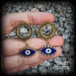 These stunning tunnel earrings feature gorgeous blue and white enamel and antique gold turkish evil eye charms, are nice and lightweight, weighing approx 10 grams each, measuring approx 5cms from tip to tip.

This pair has been made on 3/4” (19mm) gauge ornate surgical steel screw fit tunnels.