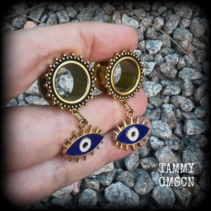 These stunning tunnel earrings feature gorgeous blue and white enamel and antique gold turkish evil eye charms, are nice and lightweight, weighing approx 10 grams each, measuring approx 5cms from tip to tip.

This pair has been made on 3/4” (19mm) gauge ornate surgical steel screw fit tunnels.