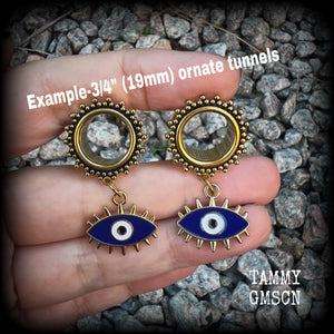 These stunning tunnel earrings feature gorgeous blue and white enamel and antique gold turkish evil eye charms, are nice and lightweight, weighing approx 10 grams each, measuring approx 5cms from tip to tip.

This pair has been made on 3/4” (19mm) gauge ornate surgical steel screw fit tunnels.
