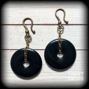 These gorgeous gemstone ear hangers feature beautiful black onyx donuts cradled in antique bronze chain, weighing approx. 24 grams a piece and measuring 8cms from tip to tip.
This pair has been made with large antique bronze shephards hooks, to be worn through earlets in stretched lobes from 2 gauge (6mm).