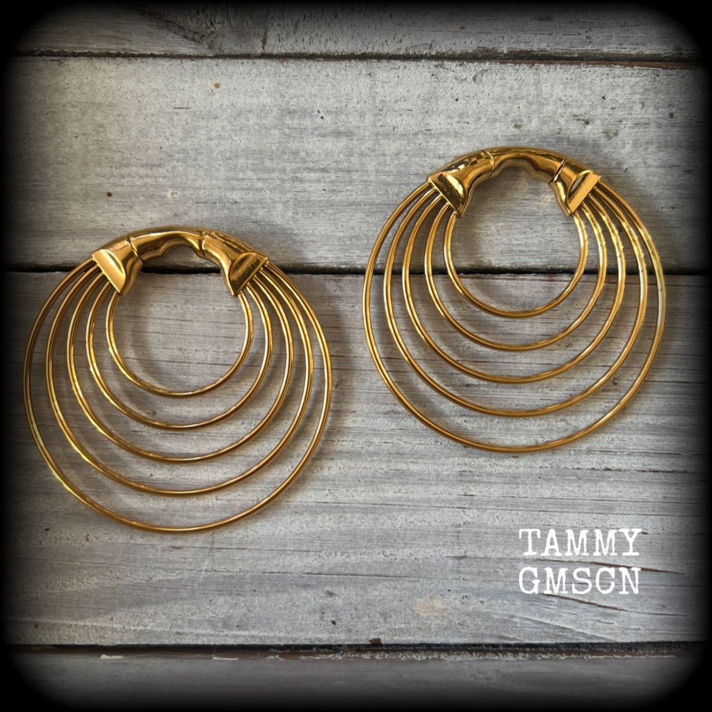 These gorgeous gold hoop gauged earrings feature beautiul titanium coated surgical steel stacked hoops, measuring just under 6cms from tip to tip, and weighing approx 13 grams each.

These are suitable to be worn in stretched lobes from 4 gauge (5mm), and will fit in earlets and tunnels in stretched lobes from 2 gauge (6mm).
