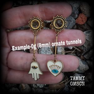 These tunnel earrings feature gold enamel hamsa hand and evil eye charms, weighing approx 9 grams each and measuring just over 6cms. This pair have been made with 0 gauge (8mm) ornate titanium coated surgical steel screw fit tunnels.