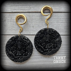These gorgeous gauged earrings feature carved black obsidian pendants, showing a phoenix and dragon encircling the I-Ching hexagram.
These earrings weigh approx. 35 grams each and measuring just under 9cms from tip to tip.
This pair has been made with 2 gauge (6mm) surgical steel full curls, suitable for stretched lobes.