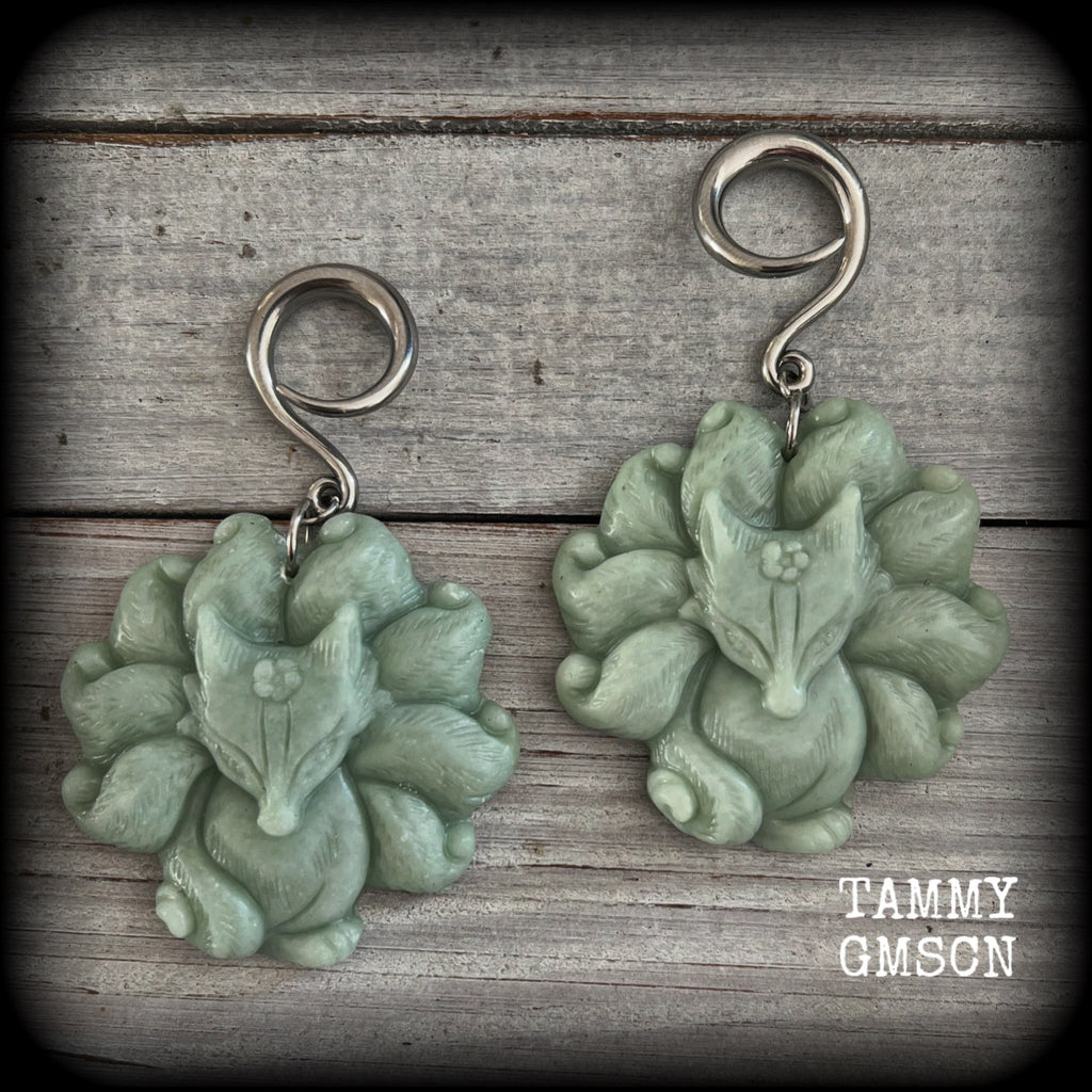 These gorgeous earrings feature carved Japanese jade kitsune, weighing approx. 25 grams each and measuring approx 7.5cms from tip to tip.
This pair have been made on 6 gauge (4mm) surgical steel full curls, suitable for stretched lobes.
