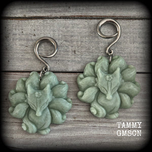 These gorgeous earrings feature carved Japanese jade kitsune, weighing approx. 25 grams each and measuring approx 7.5cms from tip to tip.
This pair have been made on 6 gauge (4mm) surgical steel full curls, suitable for stretched lobes.