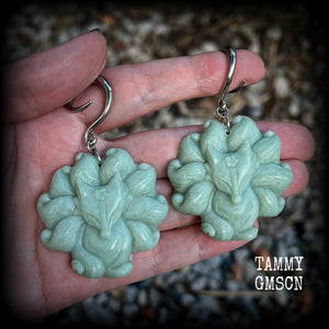 These gorgeous earrings feature carved Japanese jade kitsune, weighing approx. 25 grams each and measuring approx 7.5cms from tip to tip.
This pair have been made on 6 gauge (4mm) surgical steel full curls, suitable for stretched lobes.