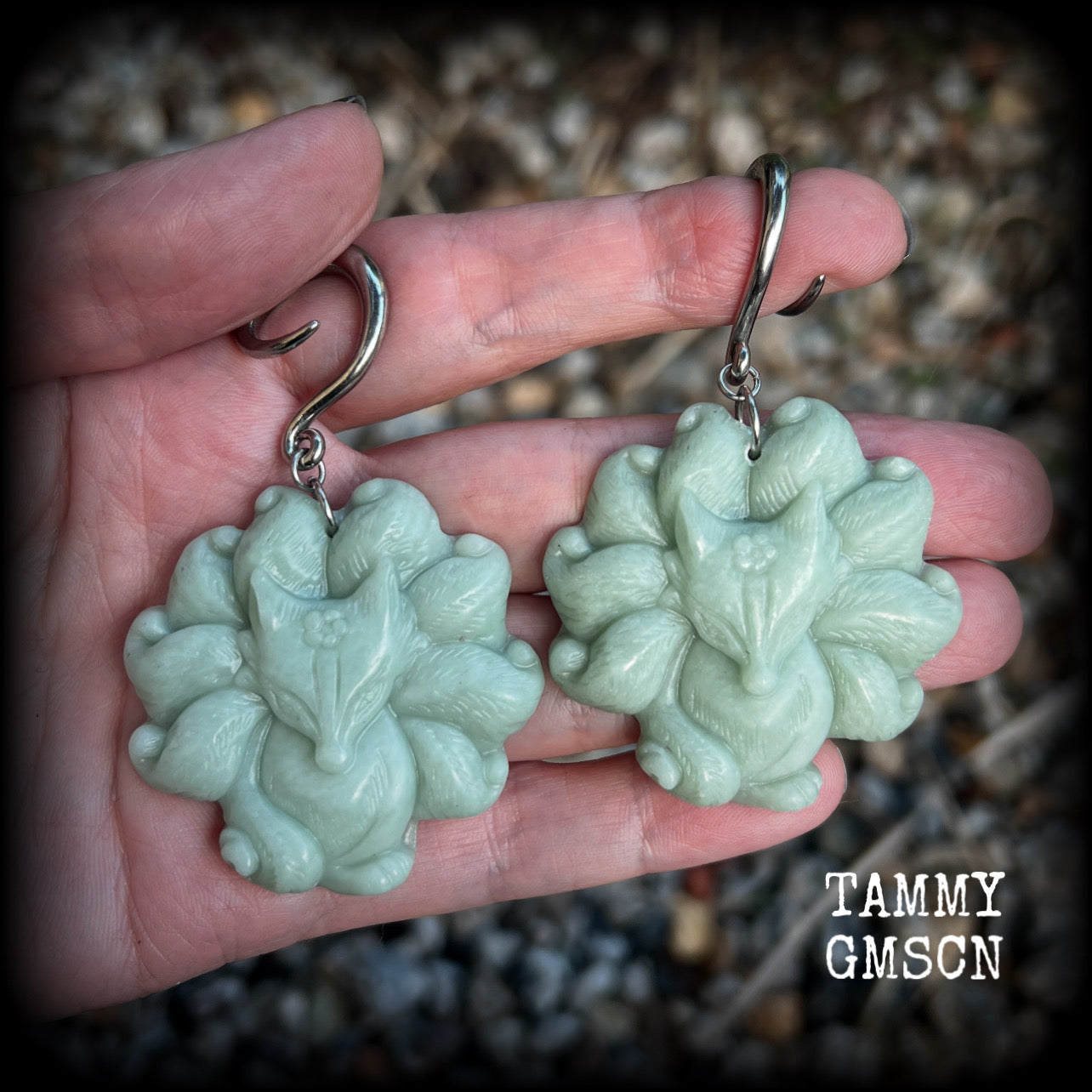 These gorgeous earrings feature carved Japanese jade kitsune, weighing approx. 25 grams each and measuring approx 7.5cms from tip to tip.
This pair have been made on 6 gauge (4mm) surgical steel full curls, suitable for stretched lobes.