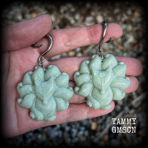 These gorgeous earrings feature carved Japanese jade kitsune, weighing approx. 25 grams each and measuring approx 7.5cms from tip to tip.
This pair have been made on 6 gauge (4mm) surgical steel full curls, suitable for stretched lobes.