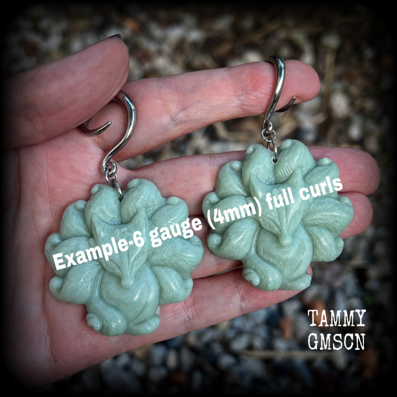 These gorgeous earrings feature carved Japanese jade kitsune, weighing approx. 25 grams each and measuring approx 7.5cms from tip to tip.
This pair have been made on 6 gauge (4mm) surgical steel full curls, suitable for stretched lobes.