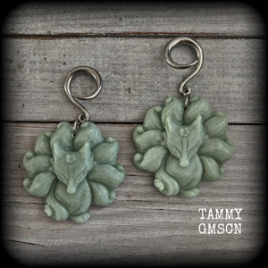 These gorgeous earrings feature carved Japanese jade kitsune, weighing approx. 25 grams each and measuring approx 7.5cms from tip to tip.
This pair have been made on 6 gauge (4mm) surgical steel full curls, suitable for stretched lobes.