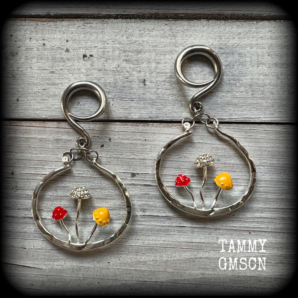 Inspired by Alice in Wonderland, these antique silver and enamel mushroom hoop gauged earrings are just gorgeous, weighing in at 10 grams a piece, and nice and dangly at just under 7cms.

This pair has been made on 6 gauge (4mm) surgical steel full curl hooks, to be worn in stretched lobes.