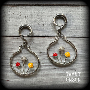 Inspired by Alice in Wonderland, these antique silver and enamel mushroom hoop gauged earrings are just gorgeous, weighing in at 10 grams a piece, and nice and dangly at just under 7cms.

This pair has been made on 6 gauge (4mm) surgical steel full curl hooks, to be worn in stretched lobes.