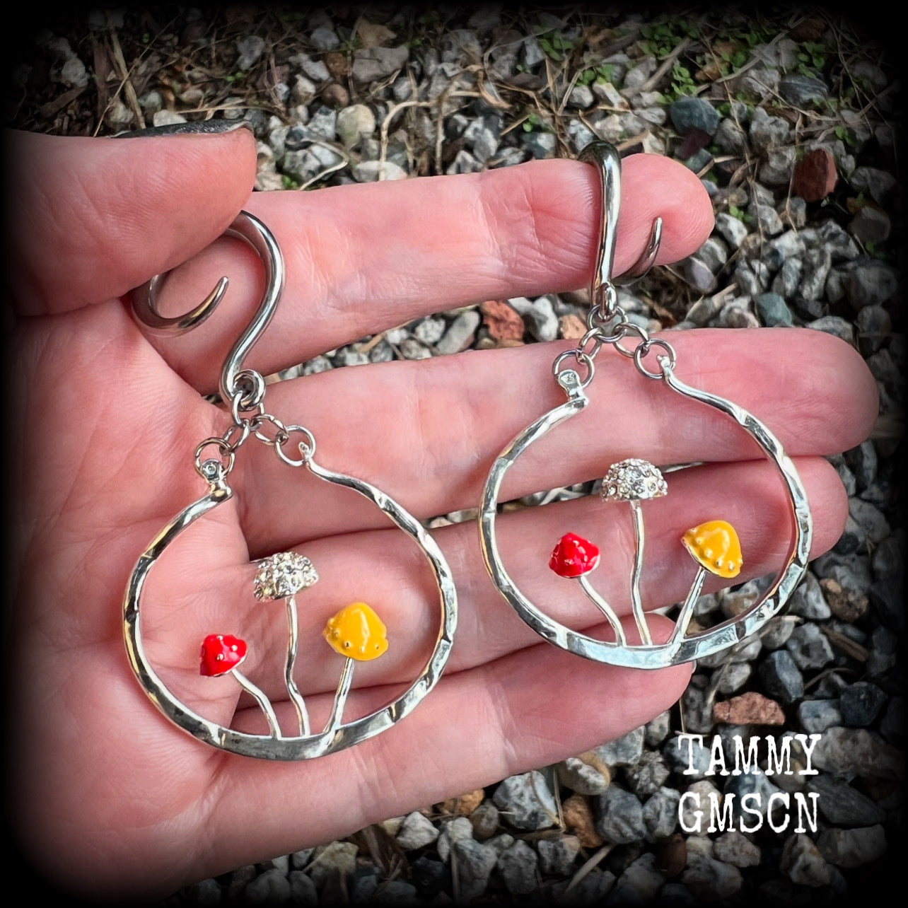 Inspired by Alice in Wonderland, these antique silver and enamel mushroom hoop gauged earrings are just gorgeous, weighing in at 10 grams a piece, and nice and dangly at just under 7cms.
This pair has been made on 6 gauge (4mm) surgical steel full curl hooks, to be worn in stretched lobes.