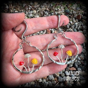 Inspired by Alice in Wonderland, these antique silver and enamel mushroom hoop gauged earrings are just gorgeous, weighing in at 10 grams a piece, and nice and dangly at just under 7cms.
This pair has been made on 6 gauge (4mm) surgical steel full curl hooks, to be worn in stretched lobes.