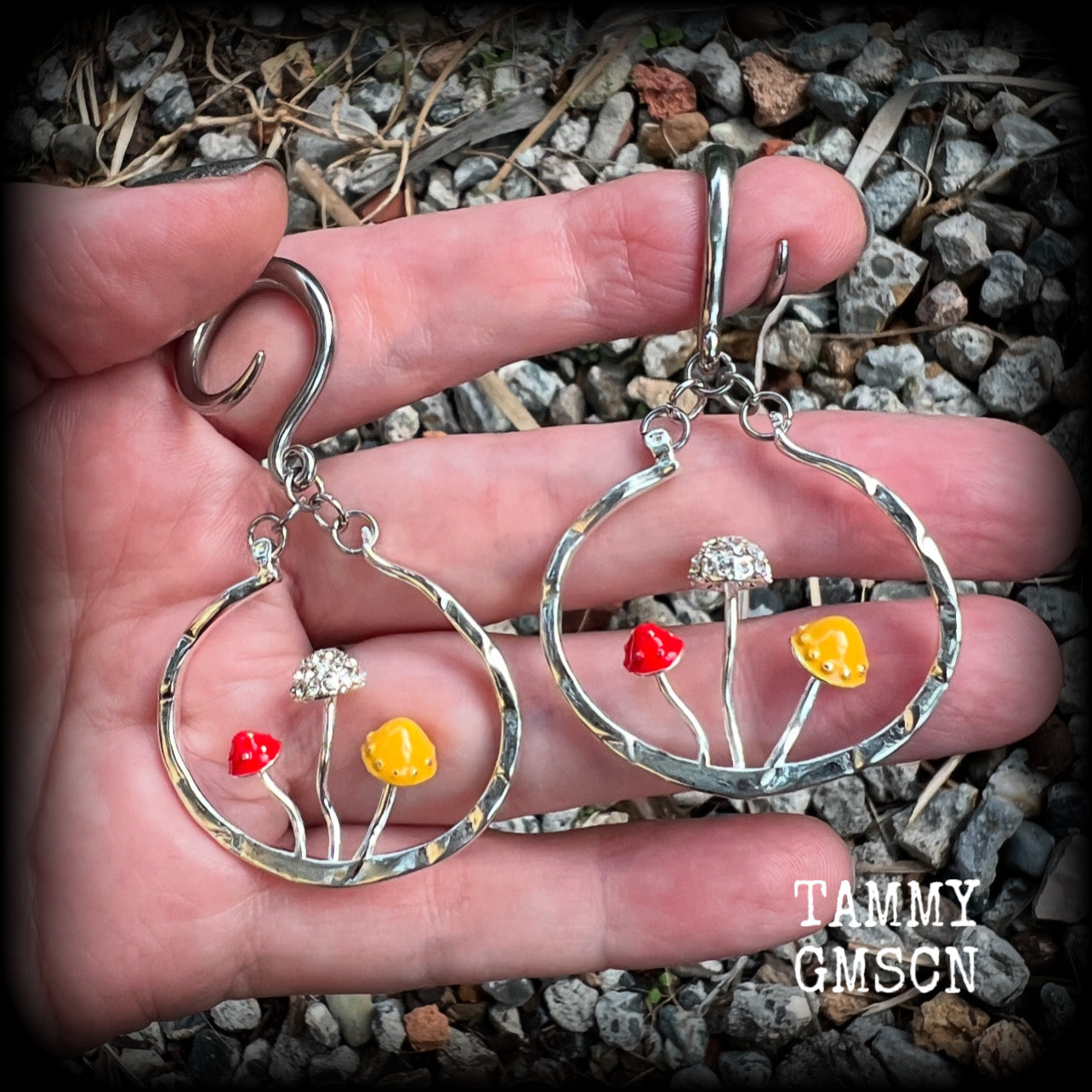 Inspired by Alice in Wonderland, these antique silver and enamel mushroom hoop gauged earrings are just gorgeous, weighing in at 10 grams a piece, and nice and dangly at just under 7cms.

This pair has been made on 6 gauge (4mm) surgical steel full curl hooks, to be worn in stretched lobes.