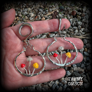 Inspired by Alice in Wonderland, these antique silver and enamel mushroom hoop gauged earrings are just gorgeous, weighing in at 10 grams a piece, and nice and dangly at just under 7cms.
This pair has been made on 6 gauge (4mm) surgical steel full curl hooks, to be worn in stretched lobes.