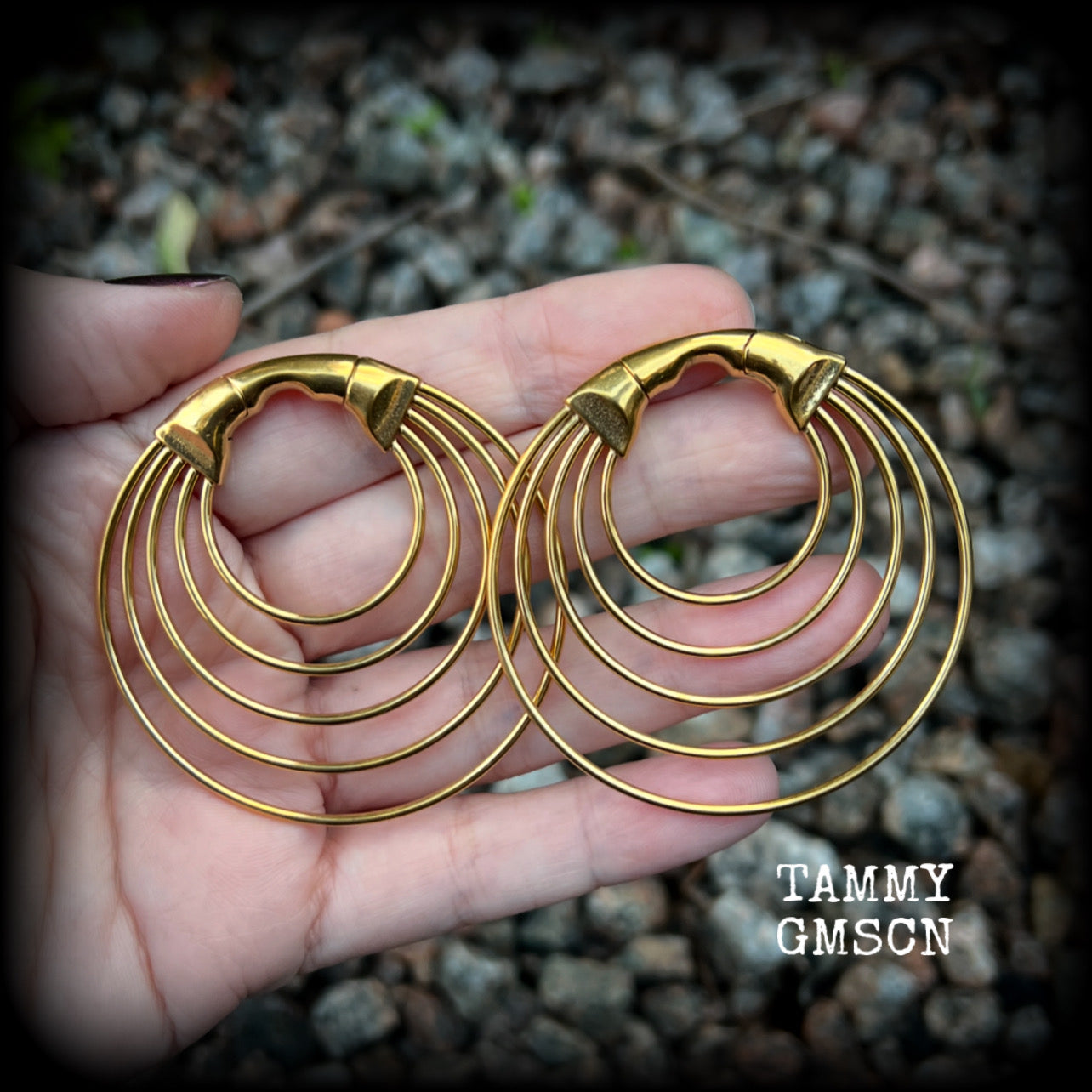 These gorgeous gold hoop gauged earrings feature beautiul titanium coated surgical steel stacked hoops, measuring just under 6cms from tip to tip, and weighing approx 13 grams each.

These are suitable to be worn in stretched lobes from 4 gauge (5mm), and will fit in earlets and tunnels in stretched lobes from 2 gauge (6mm).

