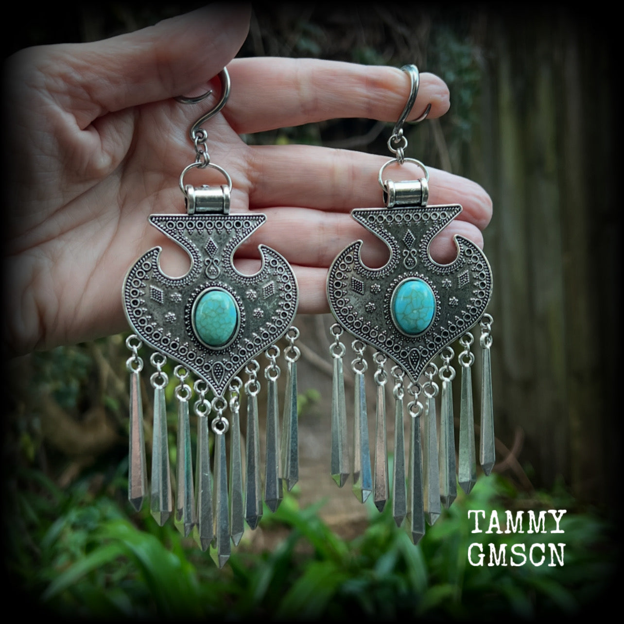 Inspired by Hathor, these unique ethnic inspired gauged earrings feature gorgeous antique silver pendants with beautiful turquoise stones.
These are gorgeous statement ear hangers, measuring just under 15cms from tip to tip and weighing in at 45 grams each they do have a nice bit of weight to them.

This pair has been made on 6 gauge (4mm) surgical steel full curl hooks, to be worn in stretched lobes.