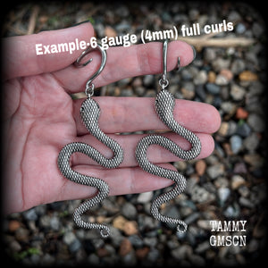 These awesome gauged earrings feature an antique silver snake, nice and dangly measuring just on 10cms from tip to tip, and weighing approx 14 grams each.
This pair has been made on 6 gauge (4mm) surgical steel full curl hooks, suitable for stretched lobes.