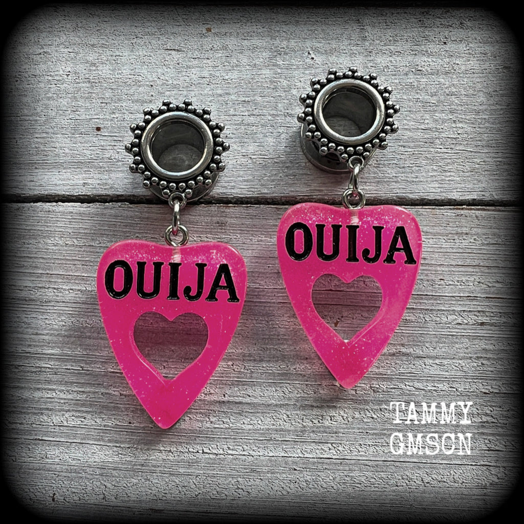 These adorable spooky tunnel dangles feature sparkly pink acrylic ouija board planchettes, are are nice and lightweight, weighing approx 6 grams each, measuring approx 5cms from tip to tip.

This pair has been made with 00 gauge (10mm) gauge ornate surgical steel screw fit tunnels, for stretched lobes.