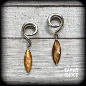 These gorgeous gauged earrings feature beautiful polished sea shell slivers, weighing in approx 10 grams a piece, and measuring approx 7cms from tip to tip.
This pair has been made on 2 gauge (6mm) surgical steel full curl hooks, to be worn in stretched lobes.