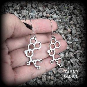 These awesome earrings feature cute little antique silver LSD molecules, measuring just over 6.5cms from tip to tip, and are nice and light weight at only a few grams each.

This pair have been made on antique silver kidney hooks, to be worn in pierced ears or stretched lobes.