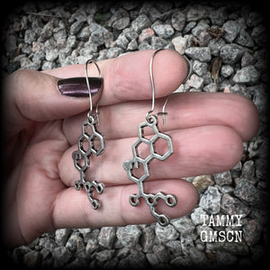 These awesome earrings feature cute little antique silver LSD molecules, measuring just over 6.5cms from tip to tip, and are nice and light weight at only a few grams each.

This pair have been made on antique silver kidney hooks, to be worn in pierced ears or stretched lobes.
