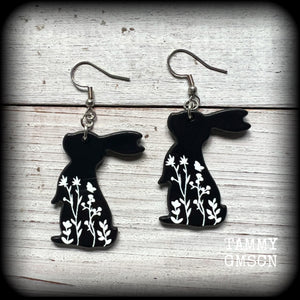 Featuring a black rabbit silhouette looking skyward with white floral sprig, these earrings are nice and lightweight, weighing only a few grams each and measure approx 6 from tip to tip.
This pair has made on stainless steel french hooks, suitable for pierced ears.