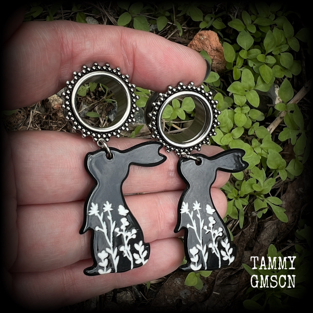 Featuring a black rabbit silhouette looking skyward with white floral sprig, these earrings weigh only 8 grams each and measure approx 6 from tip to tip. This pair has been made on 5/8” gauge (16mm) ornate surgical steel screw fit tunnels.