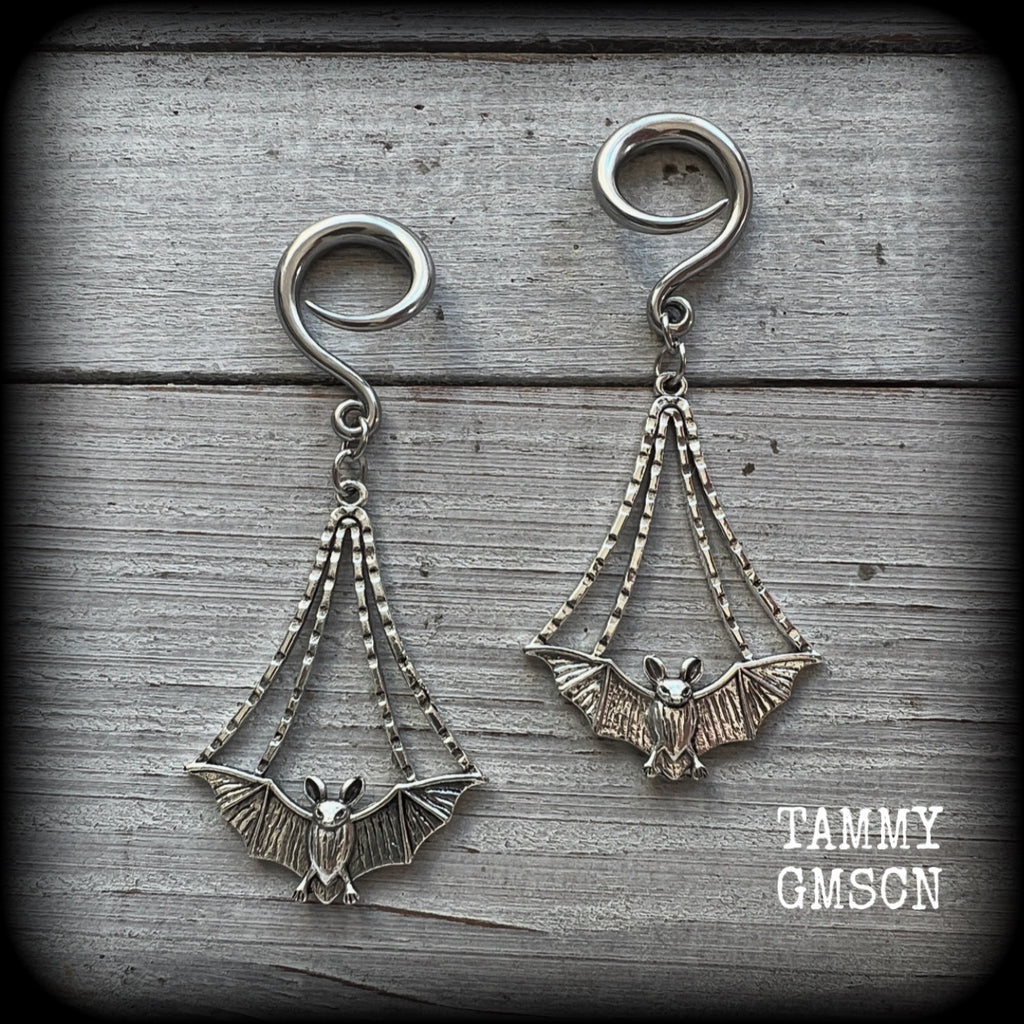 Featuring gorgeous light weight gothic silver bat charms, these spooky cute gauged earrings weigh in at 7 grams a piece, and measure just over 7cms from tip to tip.

This pair has been made on 6 gauge (4mm) surgical steel full curl hooks, to be worn in stretched lobes.